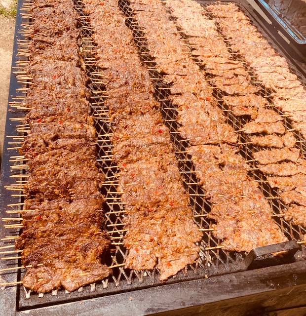 Assorted pieces of meat grilling on a grill, creating delicious smoky flavors